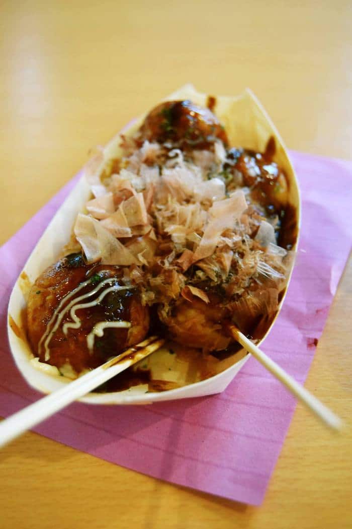 Takoyaki in Osaka Japan. This iconic food from Osaka is one of the best foods to try in Osaka. Eating IS one of the best things to do in Osaka Japan! #travel #food #osaka #japan #asia