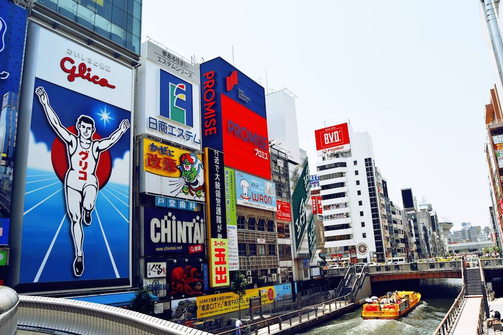 Glico Man in Osaka Japan. This iconic sight is one of the best things to do in Osaka Japan. Read more Osaka travel tips in this Osaka travel guide. #Osaka #travel #japan