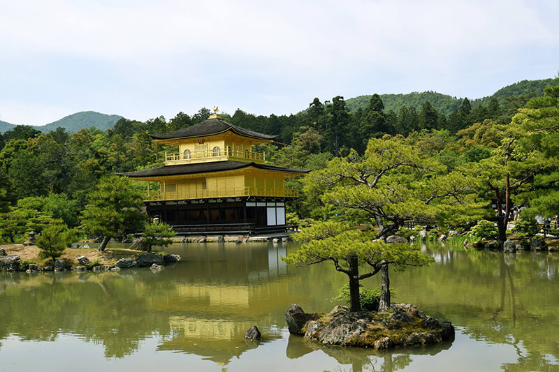 Golden Temple Kinkaku-ji Shrine in Kyoto. Read about how to visit Japan on a budget and whether if you should get the JR Pass to save money in Japan.