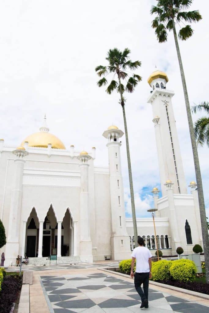 Photo of man walking towards mosque in Brunei. Read more tips on things to know about Brunei and tips for travel in Brunei. #Brunei #Travel #Asia