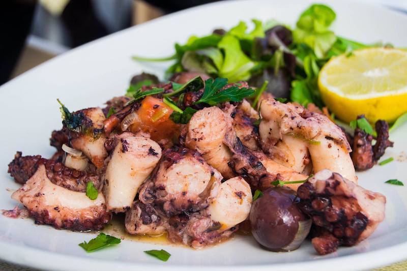 Octopus in Marsaxlokk Malta. For the best seafood in Malta, you must visit Marsaxlokk, a fishing village outside of Malta. Read what to do on a weekend break in Malta! #travel #food #malta #europe #seafood