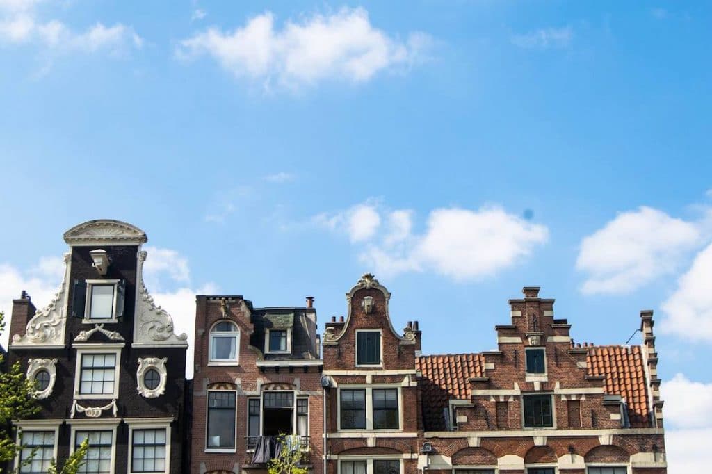 Amsterdam houses. Read what to pack for Europe in a guide by an American expat. #travel #europe #packing #amsterdam