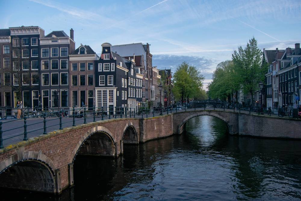 Photo of canals of Amsterdam. Read tips for the best things to do in Amsterdam on a budget with insider tips for the best free things to do in Amsterdam. #travel #Netherlands #amsterdam