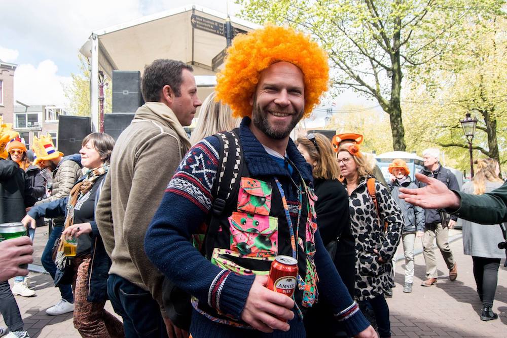 Man dressed up for King's day in Amsterdam. Read tips for celebrating King's Day in Amsterdam, the Netherlands!