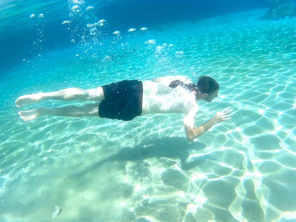 Man swimming in natural spring in Rainbow Springs State Park, a day trip from Orlando Florida. 