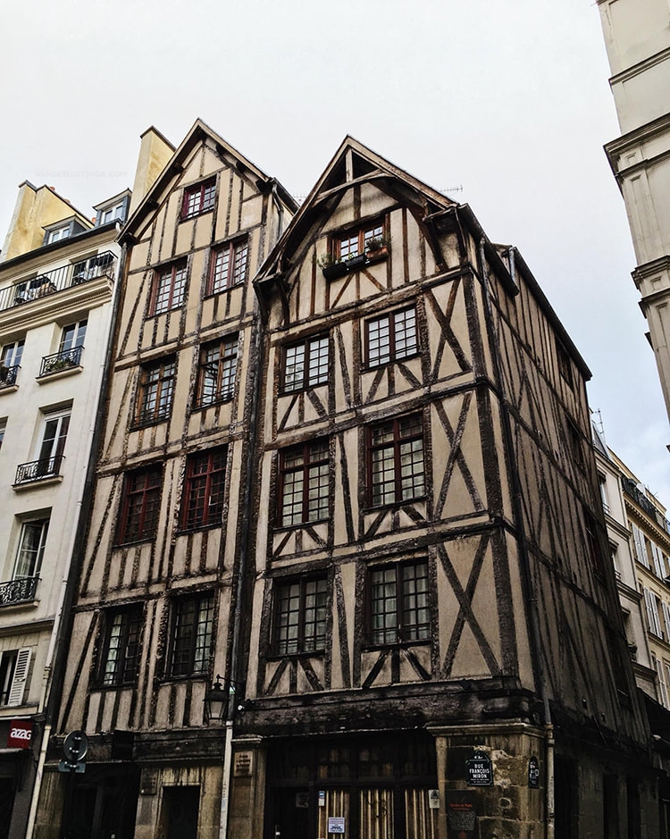 Beautiful building in the Marais Paris. Read a local's guide to Paris with insider tips for off the beaten path Paris on a budget. #Paris #France #Travel