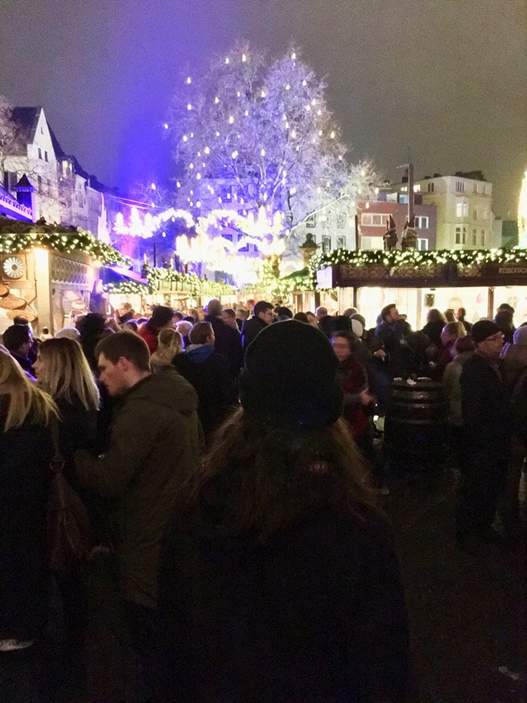 Man in the Alter Markt Christmas Market in Cologne Germany, the most famous christmas market in Cologne.