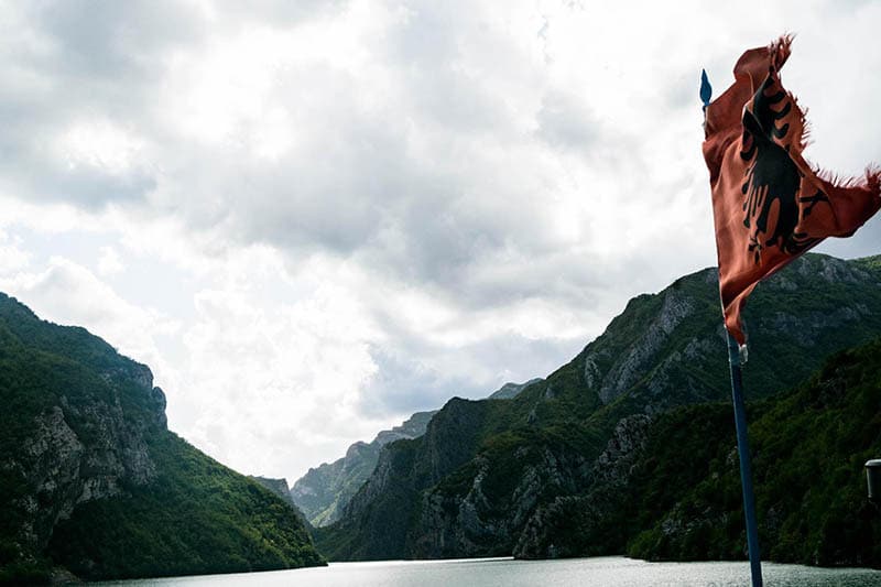 Photo of Albanian flag on Lake Koman Ferry. 