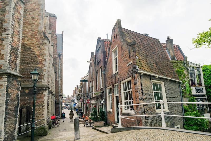  Photo of beautiful street in Delft. Follow this Delft itinerary for the perfect one day trip to Delft with insider tips on where to eat in Delft and what to do in Delft.