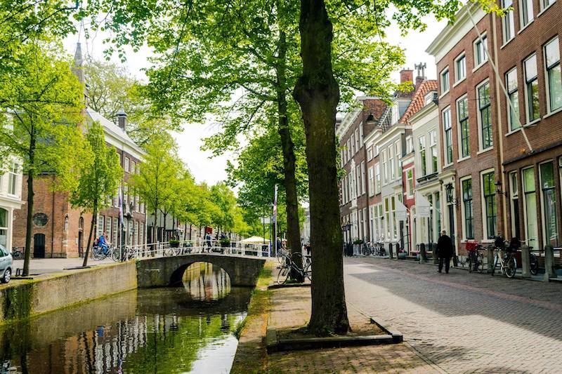Photo of Oude Delft canal in Delft. This beautiful canal is a must-see in Delft, one of the cities that you need to visit in the Netherlands! Be sure to include it in your itinerary! #Netherlands #Delft #Travel