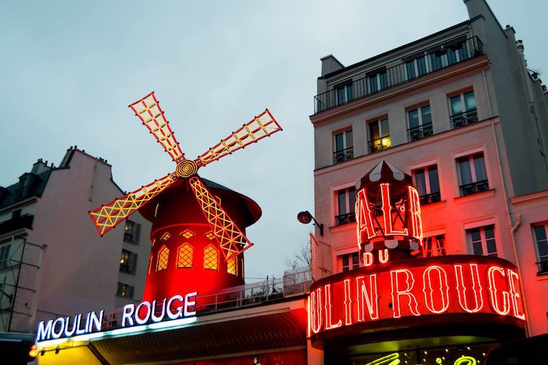 Le Moulin Rouge, one of the most iconic attractions in Montmartre that you will see along this free walking tour of the 18th arrondissement. #paris #france #travel