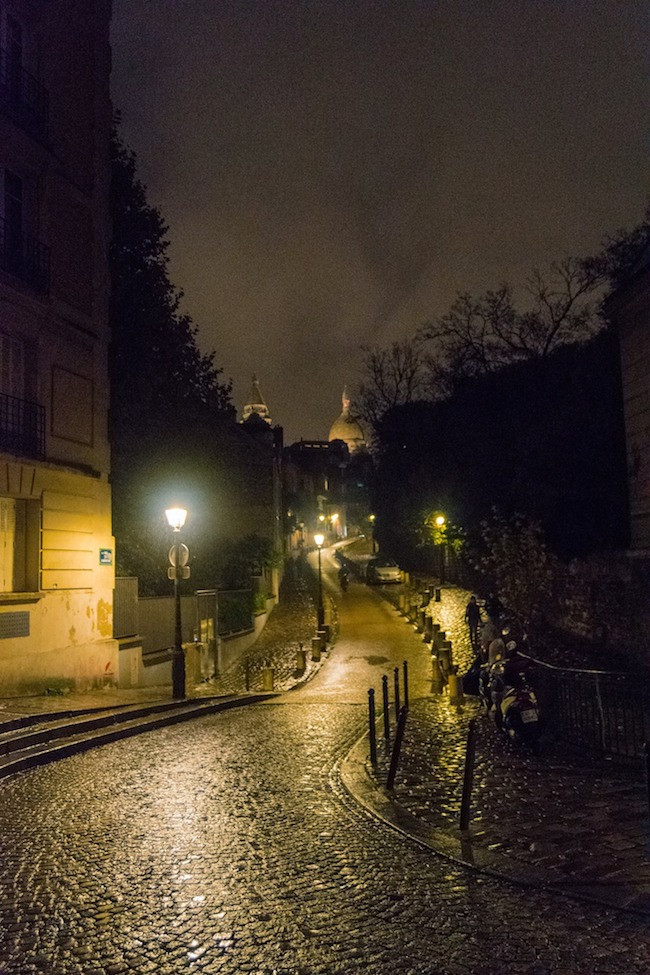 Montmartre at night. This beautiful view can be seen from Place Dalida, one of the stops on a free self-guided walking tour of Paris' 18th arrondissement. #travel #paris #france