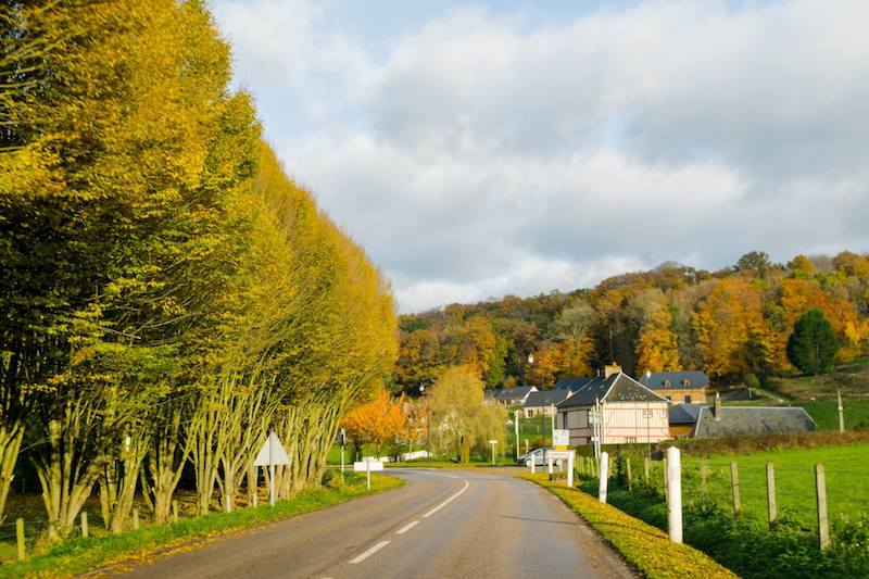 Scenic road with chateau in Parc Naturel Régional des Boucles de la Seine, one of the most beautiful places to visit in Normandy. This beautiful park makes for a scenic road trip in Normandy! #travel #Normandy #france