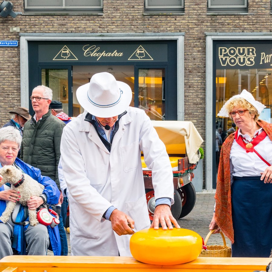 Merchant tasting the cheese at the Woerden kaasmarkt, one of the Dutch cheese markets. This one is 100% real! #travel #netherlands #cheese #gouda