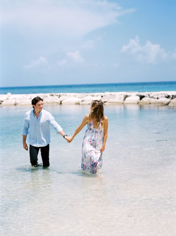 Photo of couple holding hands in water from elopement in Montego Bay. 