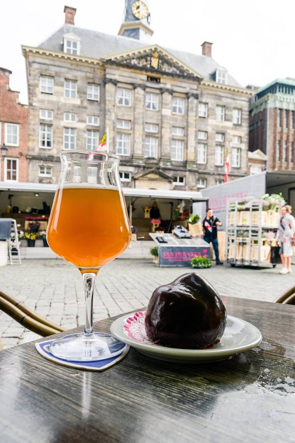 Bossche bol (chocoladebol) and a local beer with a view of Den Bosch ('s-Hertogenbosch). This local Dutch dessert must be tried if you visit Den Bosch! #travel #nederland #netherlands #brabant