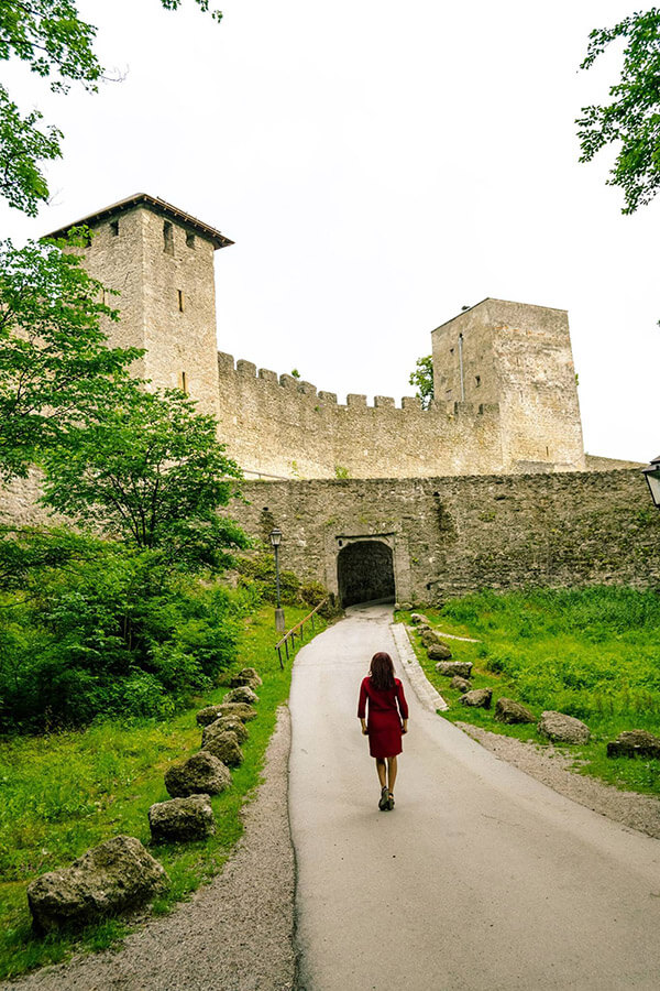 Woman admiring the stunning walls of Bürgerwehr Mönchsberg, the old city walls of Salzburg.  This secret place in Salzburg is a local secret! #salzburg #austria