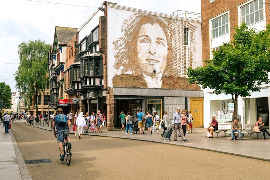 Scenic street view of downtown Exeter, Devon, United Kingdom with a mural.