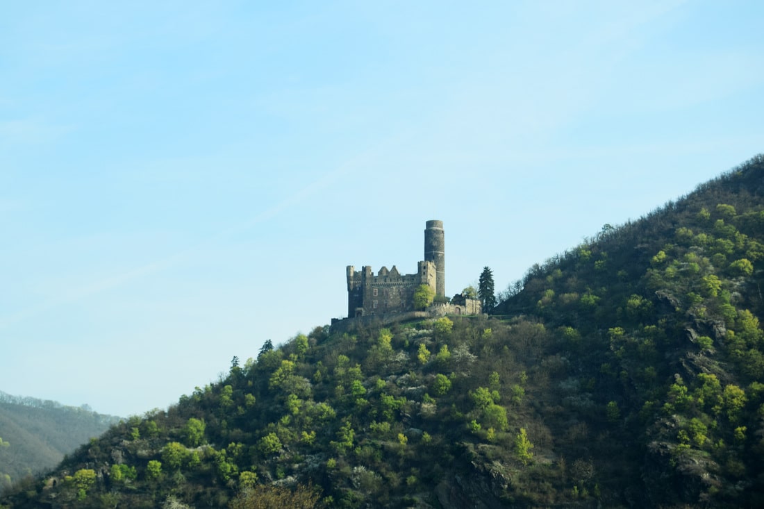 Visit the Rhine Valley wine region in Germany on a budget, including staying IN a castle, which Rhine Valley castles to visit, which towns to explore, and taste the famous wine. All without a river cruise!