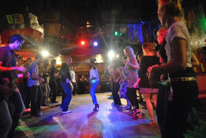 People dancing at a Paris salsa club during a meet-up with a local while traveling