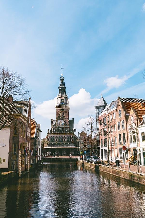 Beautiful view of canal houses and Alkmaar Cheese Market Square over a canal. 