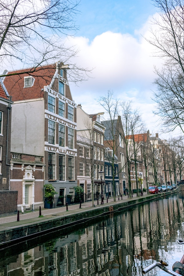 Oudezijds Achterburgwal is one of the most picturesque streets in Amsterdam.  This street at the heart of the red light district is worth seeing! #travel #holland #netherlands #amsterdam