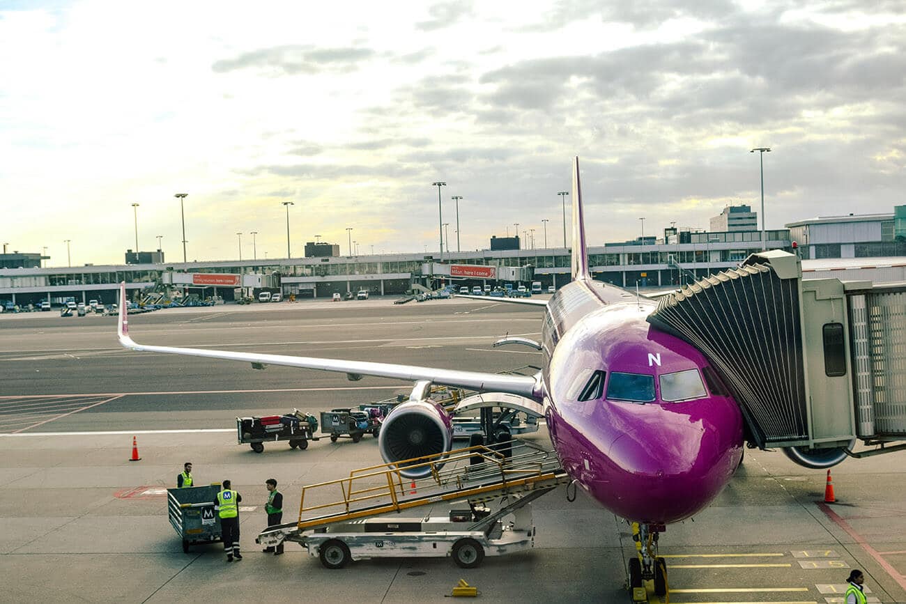 WOW air plane being loaded at JFK airport.  This budget Icelandic airline is a popular choice for cheap flights to Iceland.