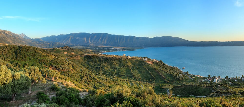 Mountains and sea in Vlore, Albania. This beautiful seaside city in Albania is famous for its beautiful beaches. If you're visiting the Balkans, visit the Albanian Riviera for stunning beaches! #beaches #Albania #Balkans #travel #Europe #Vlore