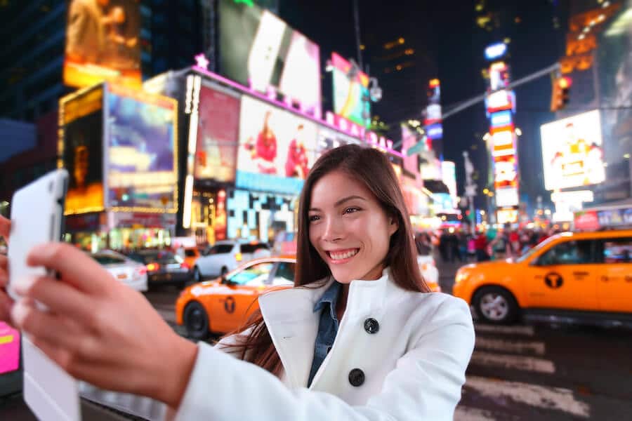 Woman in Times Square, one of the highlights of visiting New York City that can't be left off your New York plans! #travel #NYC