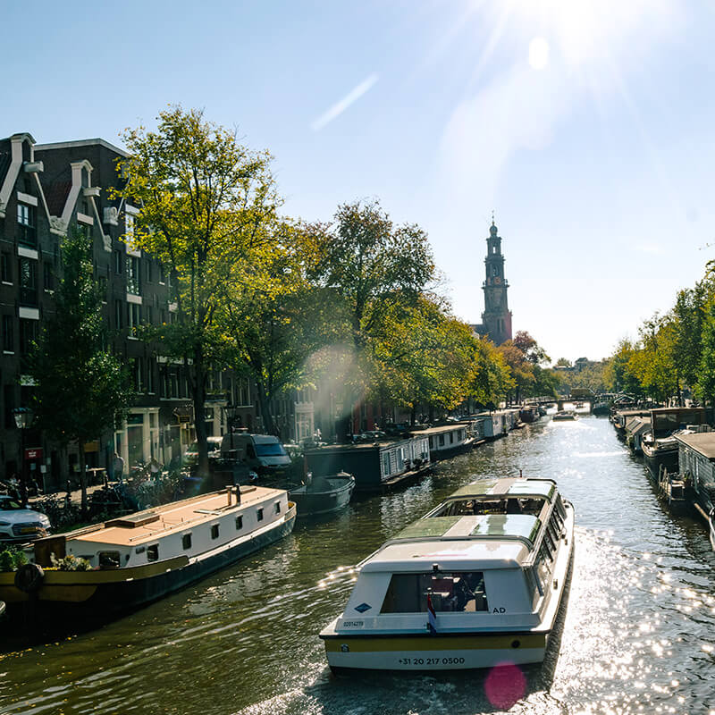 Canal boat cruising down beautiful canal (Prinsengracht) in Amsterdam.  This is the canal where Anne Frank's house is located and where you can see the Westerkerk.  #amsterdam #holland #netherlands #nederland #travel