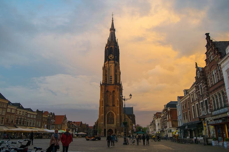 Photo of Delft at sunset. Perfect day trip around amsterdam and one of the most beautiful places to visit in the netherlands