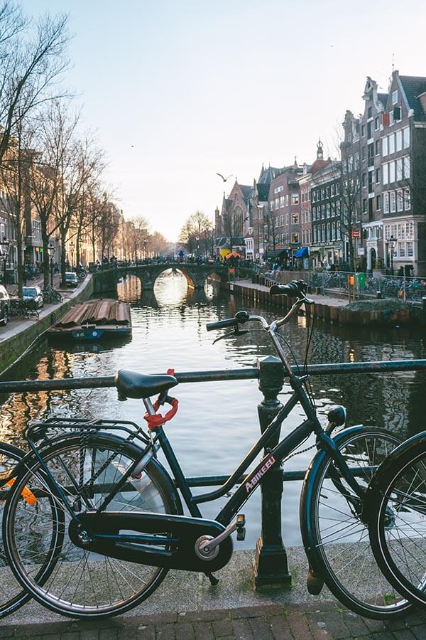 Bicycle with beautiful view of Amsterdam, one of the highlights of Holland