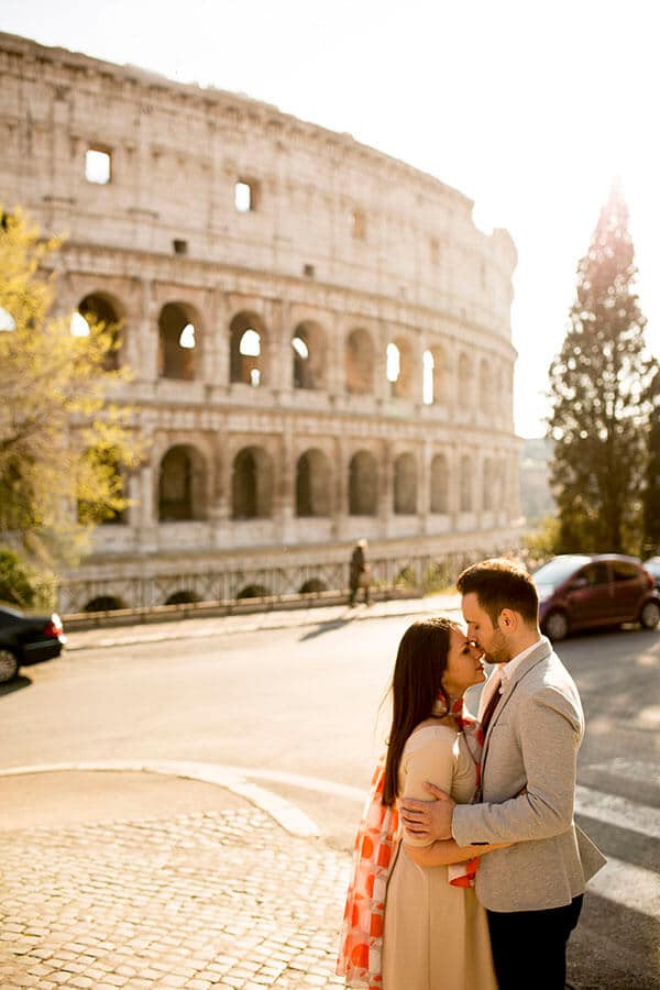 Newly married couple outside of the Roman Coliseum in Rome, Italy enjoying their honeymoon in Italy!