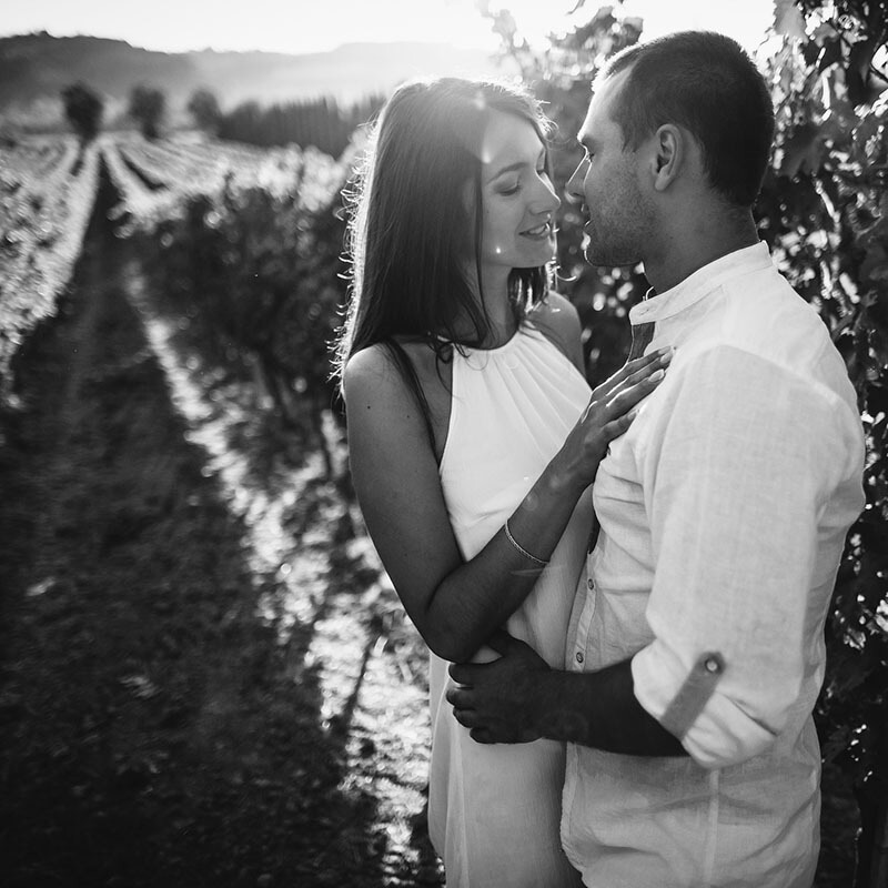 Couple enjoying a romantic vineyard visit during their honeymoon in Italy