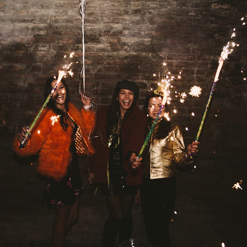 Women celebrating New Year's Eve in Icealnd with sparklers!