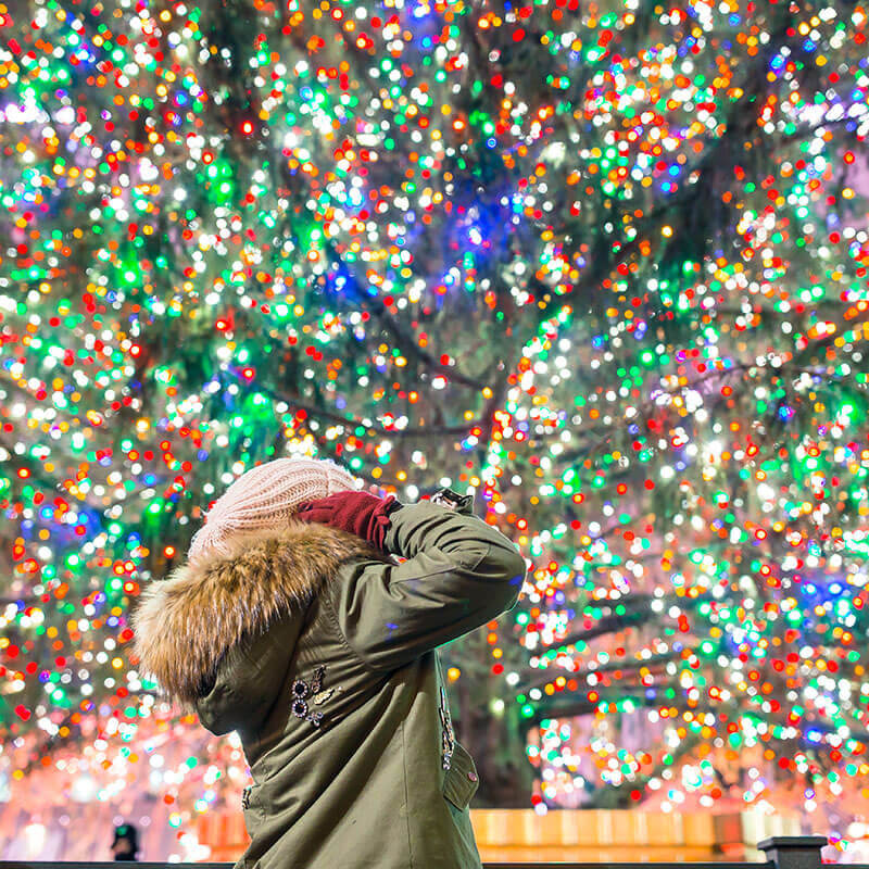 Woman enjoying Christmas Day in New York City, one of the best times to enjoy NYC!