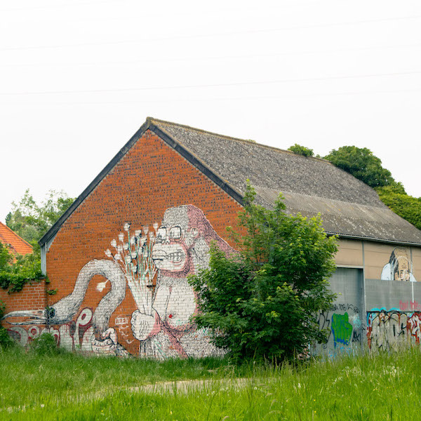 Street art on the buildings of Doel, Belgium. This Belgian ghost town is famous for its street art. #travel #streetart #belgium #doel