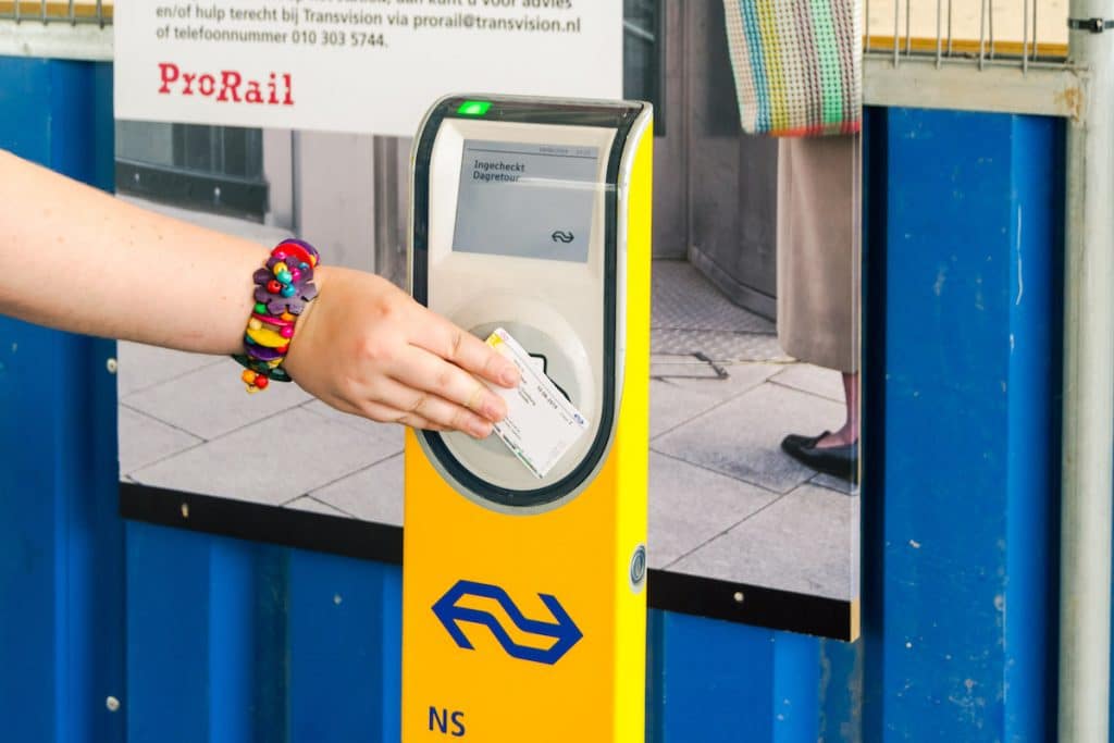 Girl using the Dagkaart, one of the best ways to save money on the Dutch trains and buy discount train tickets in the Netherlands. #dutch #trein #travel