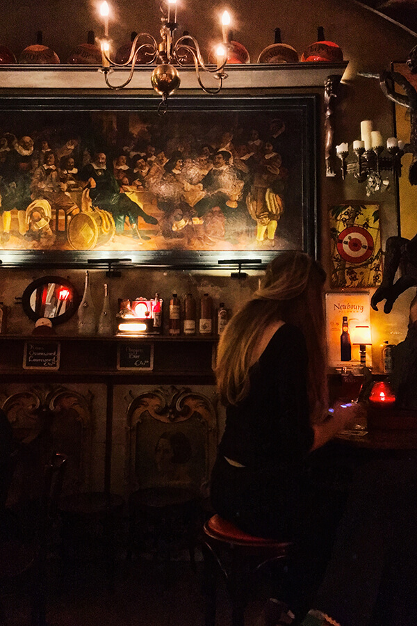 Girl enjoying a date at a brown bar in Amsterdam.  One of the most romantic things to do in Amsterdam is to go for a jenever tasting together! #amsterdam 