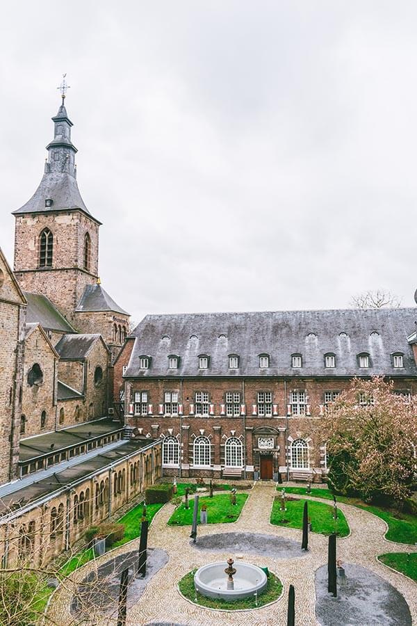 Photo of Abdij Rolduc, an abbey hotel in the Netherlands near Aachen, with a picturesque courtyard.