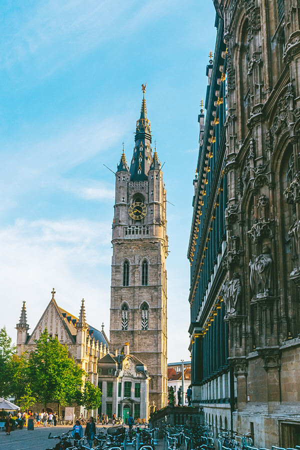 Beautiful Belfry of Ghent in Gent, Belgium.  This UNESCO recognized attraction in Belgium is set against a blue sky!