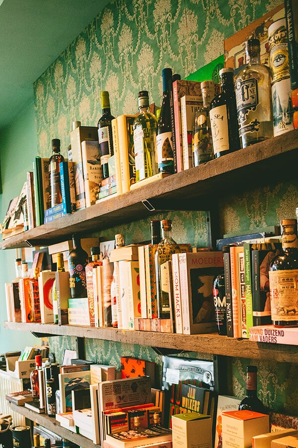 Books and bottles of liquor at a unique shop in Ghent, Belgium