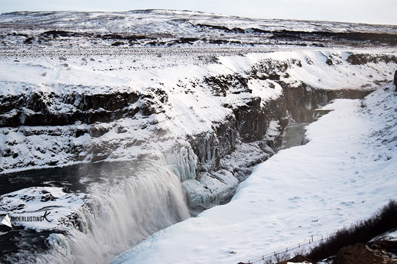 Photo of frozen waterfall in Iceland in winter. Read more about driving Ring Road in winter.