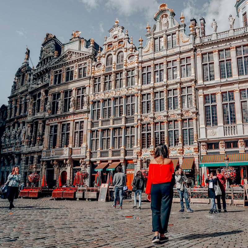 Girl walking through Grand Place in Brussels, one of the most beautiful places to visit in Europe! #belgium #brussels #travel #europe