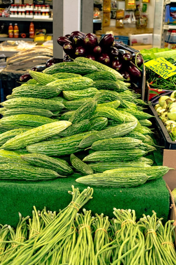 Colorful Surinamese vegetables at the Hague Market (Haagse Market) in the Hague! This colorful market is a must-see for food lovers due to its fantastic assortment of fruit, veggies, and street food! #hague #holland #travel #netherlands