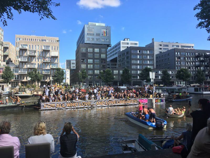 Modern scene on Pride in Amsterdam showing off modern rentals in Amsterdam.  Read how to find a flat in Amsterdam for expats!