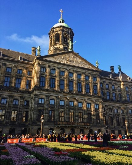 Dam Square in Amsterdam. Traveling to Amsterdam? Read the ultimate guide with insider local tips for what to do in Amsterdam, what to eat in Amsterdam, and where to stay in Amsterdam! #travel #Amsterdam