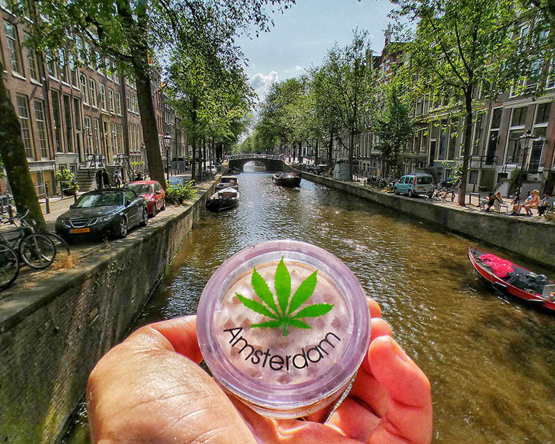 Amsterdam weed container with marijuana symbol with background of Amsterdam canals