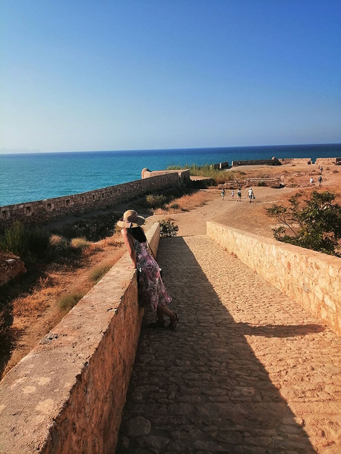 Girl enjoying the fortress in Rethymno, Crete with views of sea