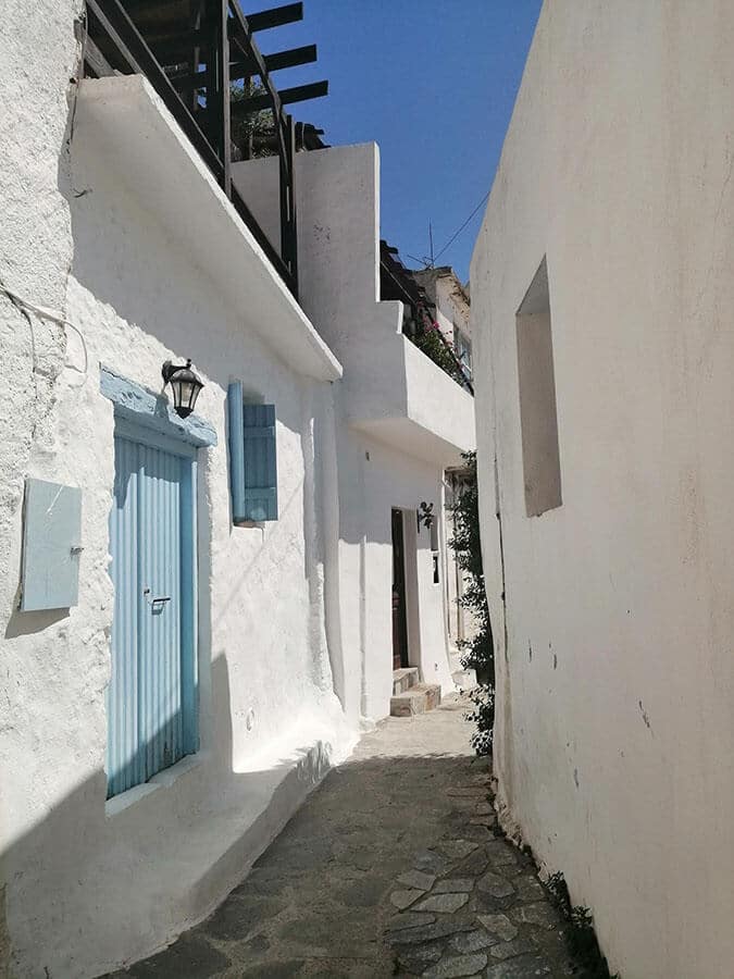 Beautiful white walls and blue doors in Mirthios, a charming village near Plakia, Crete, Greece. 